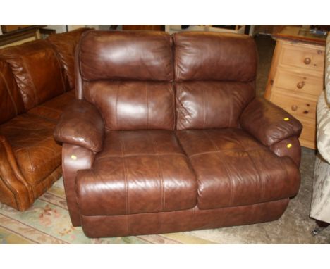 A MODERN TWO SEATER BROWN LEATHER SOFA