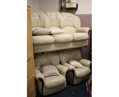 A VINTAGE LEATHER THREE PIECE SUITE COMPRISING THREE SEATER SOFA AND TWO MATCHING CHAIRS