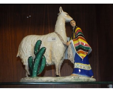 AN ITALIAN CERAMIC FIGURE OF BABY WITH ALPACA 