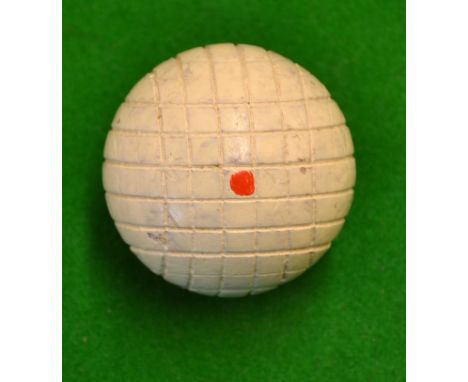 Scarce line cut wooden golf ball with red dots to both poles and retaining all the original white enamel finish