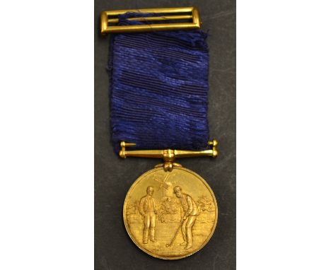 Fine gilt golfing medal and ribbon c.1900 - the obverse finely embossed with golfing figure, his caddy and Windmill in the ba