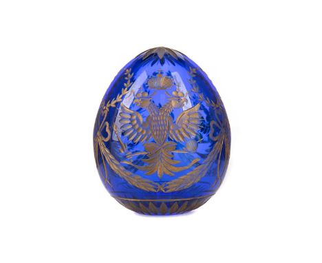 20TH CENTURY FABERGÉ PARCEL-GILT AND BLUE GLASS EGG,cut with Russian Imperial double-headed eagles interspersed with foliate 
