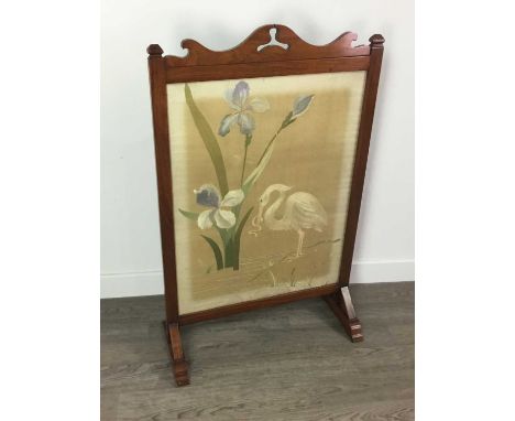 FIRESCREEN INSET WITH A NEEDLEWORK PANEL,early 20th century, mahogany framed, the panel behind glass, on shaped supports, 59c