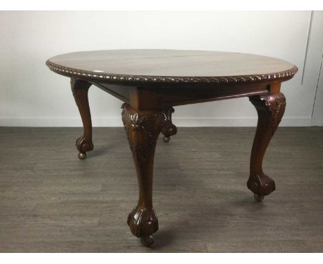 MAHOGANY DINING TABLE OF CHIPPENDALE DESIGN,with gadroon moulded edge, on castors, 238cm long when extended