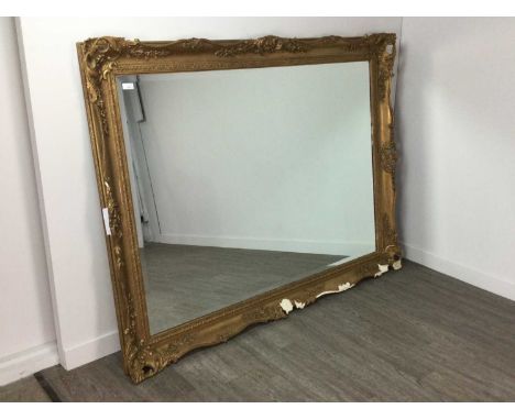 GILT FRAMED OVER MANTEL MIRROR,with bevelled oblong glass, the stucco frame moulded with shells, scrolls and foliage, 128cm x