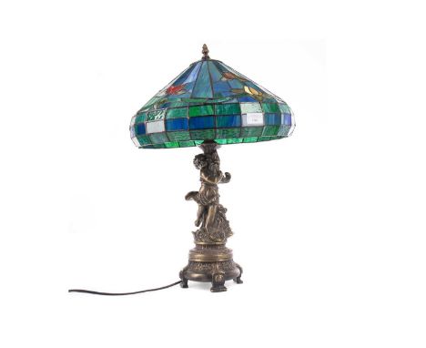 TABLE LAMP WITH TIFFANY STYLE LEADED AND STAINED SHADE,the column modelled as a putto with bronzed finish, approximately 61cm