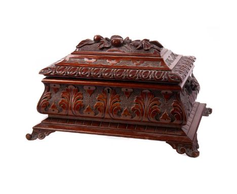 VICTORIAN CARVED WALNUT TEA CADDY,the hinged cover carved with foliage within an egg and dart border, opening to reveal an in