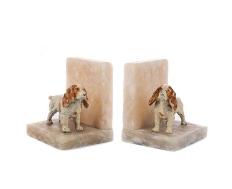 PAIR OF EARLY 20TH CENTURY ART DECO BOOKENDS,cold-painted spelter spaniels on mottled hardstone bases, 11.8cm high, 10.6cm wi