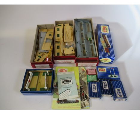 Hornby Dublo trackside accessories comprising engine shed, goods depot, suburban station, level crossing, T.P.O. set, signals