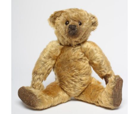 A pre-war Farnell teddy "Archie", with long orange plush, button eyes, re-sewn nose, fabric pads, swivel joints and hump, 13"