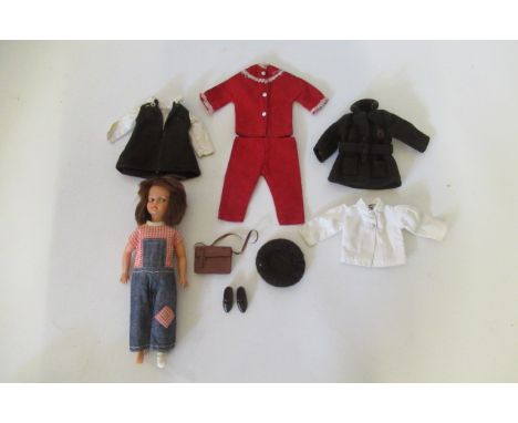 A Sindy Patch, made in Hong Kong, with sideways glancing eyes and an assortment of original clothing, 8 1/2" long (Est. plus 