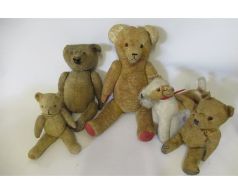 Four early soft toys and a vintage dog, comprising an 18 1/2" straw filled centre seam teddy with button eyes and hump, two s