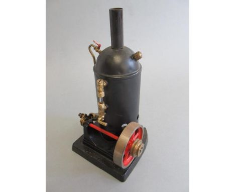 Small vertical spirit fired steam engine, single cylinder, domed boiler, with water gauge, on cast iron base, 10cm x 10cm x 2