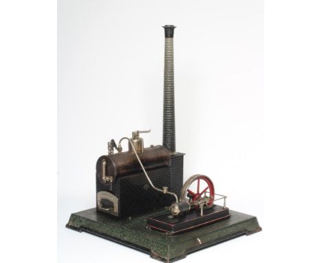 A large Carette single cylinder stationary steam engine, plated black boiler with brick base and chimney, large plated flywhe