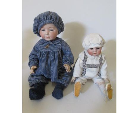 A rare Swaine & Co. bisque socket head solemn boy doll, with blue glass sleeping eyes, open-closed mouth, moulded and painted