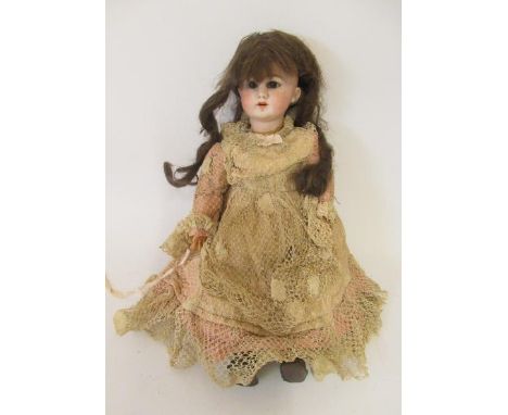 A French bisque socket head walking doll, with brown glass fixed eyes, open mouth, teeth, pierced ears, wood and composition 