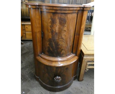 A Victorian mahogany bow front commode with sliding cupboard over 