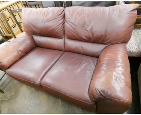 A two seater settee in brown leather with matching pouffe stool 