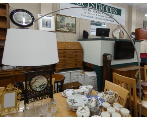 A contemporary chrome framed angle lamp standard with shade 
