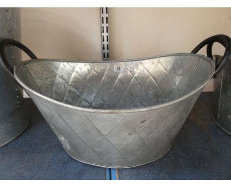 A galvanized oval planter - 41cm x 31 cm x 18 deep