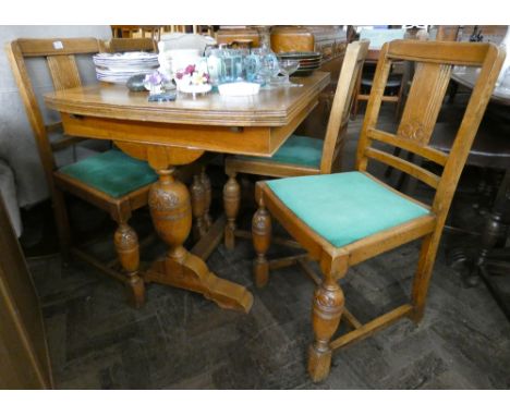 A 3' light oak draw leaf dining table on refectory style bulbous base and four matching chairs with green upholstered seats 