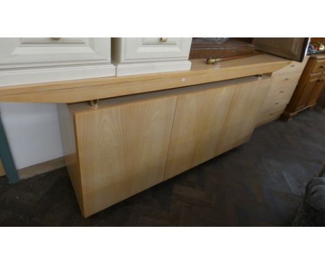 A long modern light beech finished sideboard fitted three doors, 7' long  