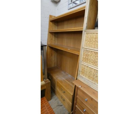A light oak graduated open bookcase with drawers and cupboards under 4' wide 