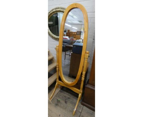An oval Cheval dressing mirror in light beech frame 