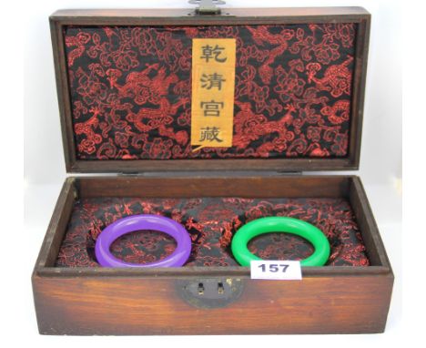 A Chinese wooden presentation box containing two jade bangles, internal Dia. 6cm. W. 13.5mm.