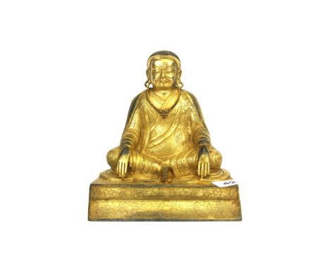 A Tibetan gilt bronze seated Buddhist Deity, H. 19cm.