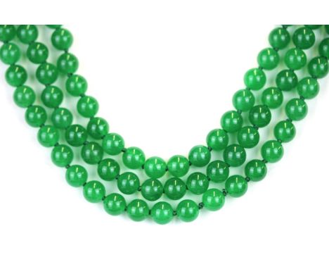 A lovely three row necklace of green jade beads, the bead size 8mm, the necklace L. 40cm, on a white metal rhodium plated cla