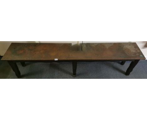 An arts and crafts oak and hammered copper garden bench, cut to fit around a tree or upright post, L. 193cm.