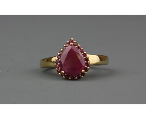 A 9ct yellow gold ring set with pear cut ruby surrounded by rubies, (P).