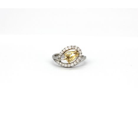 AN 18ct white gold (stamped 750) ring set with a rose pear cut fancy yellow diamond (approx. 0.90ct) surrounded by brilliant 