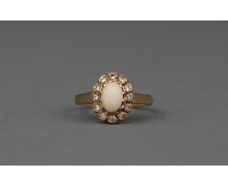 A 9ct yellow gold opal and white stone set cluster ring, (K.5).