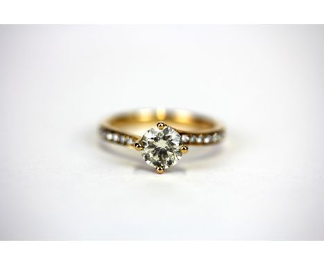 An 18ct rose gold solitaire ring set with a 1ct brilliant cut diamond and diamond set shoulders, (K).