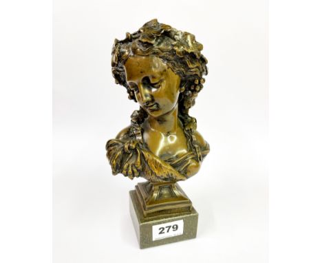 A bronze bust of a lady on a hardstone pedestal, H. 21cm.