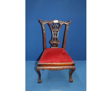 An elegant and charming miniature Chippendale style Mahogany side Chair having a carved and fretworked backrest, a drop-in ma