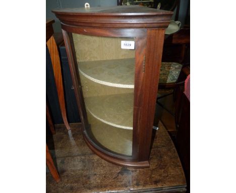 A Mahogany framed curved glass doored wall hanging display Cabinet with an olive green lined interior, 20'' wide x 26'' high 