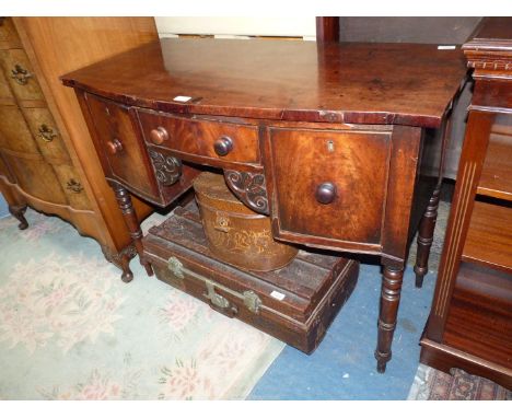 A 19th c. bow fronted Mahogany Sideboard of unusually compact dimensions and with a central frieze drawer flanked by to the l