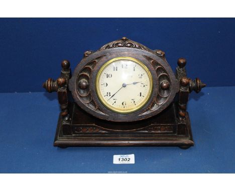 A swing Mantle clock in carved frame.