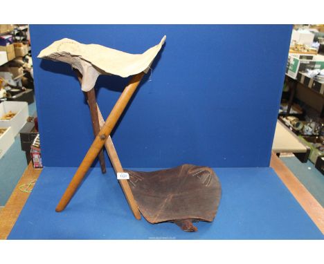A Campaign folding tripod stool, 19th century, with both leather and canvas seating slings.