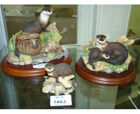 Three Border Fine Arts (including one Studio) Otter ornaments;  'The Poacher' (a/f.), 'Safe Haven' and 'First Outing'.