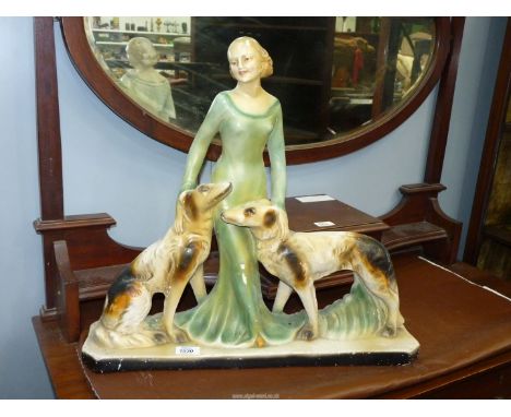 An Art Deco chalk figure of Lady with dogs, 23" x 21" high, some wear.