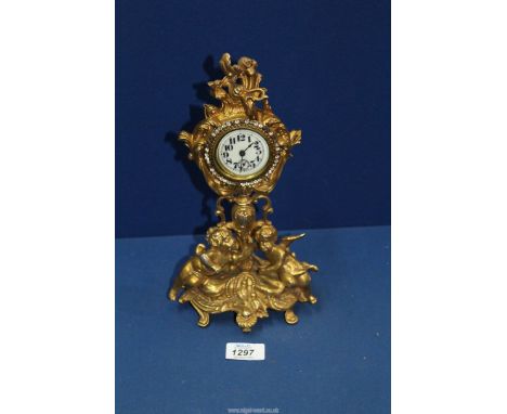 A gilded Mantle clock with stones around bezel, 11" tall.