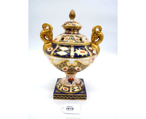 A Davenport pot pourri urn with lid in Imari pattern, with two goats head on square foot, (large crack to body and base) with