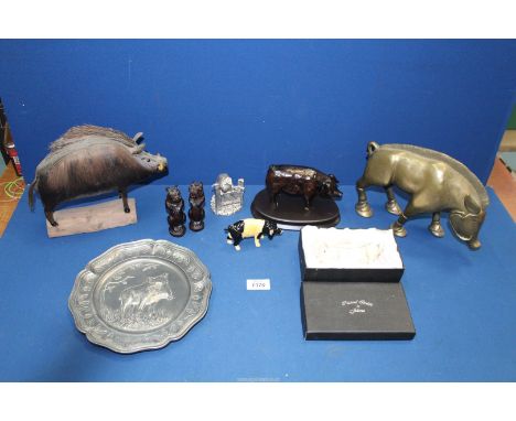 A quantity of pigs including stylised metal boar, two pig trinket pots, pewter plate with wild boar decoration, wooden hippop