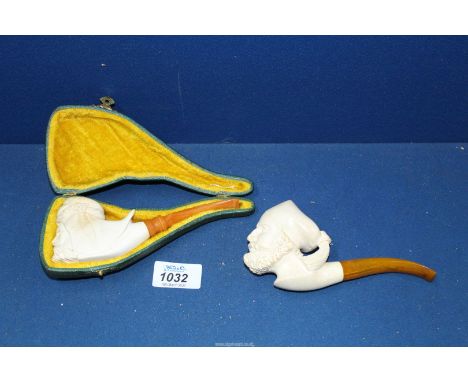 Two meerschaum Pipes, one pipe cased, carved with the head of a bearded Arab with headdress, the other uncased pipe carved as