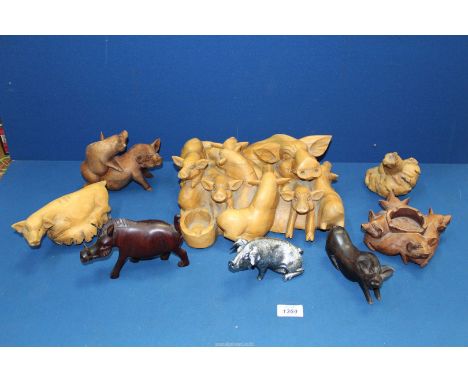 A quantity of wooden pigs including root carvings, tea light holders, large stylised sow and piglets carving, etc.