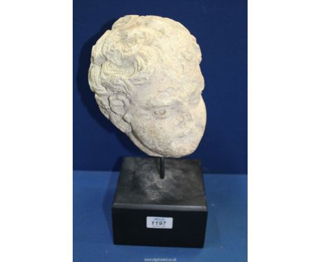 A very early life size marble head from a free standing figure of a young child. With finely chiselled hair and a few traces 
